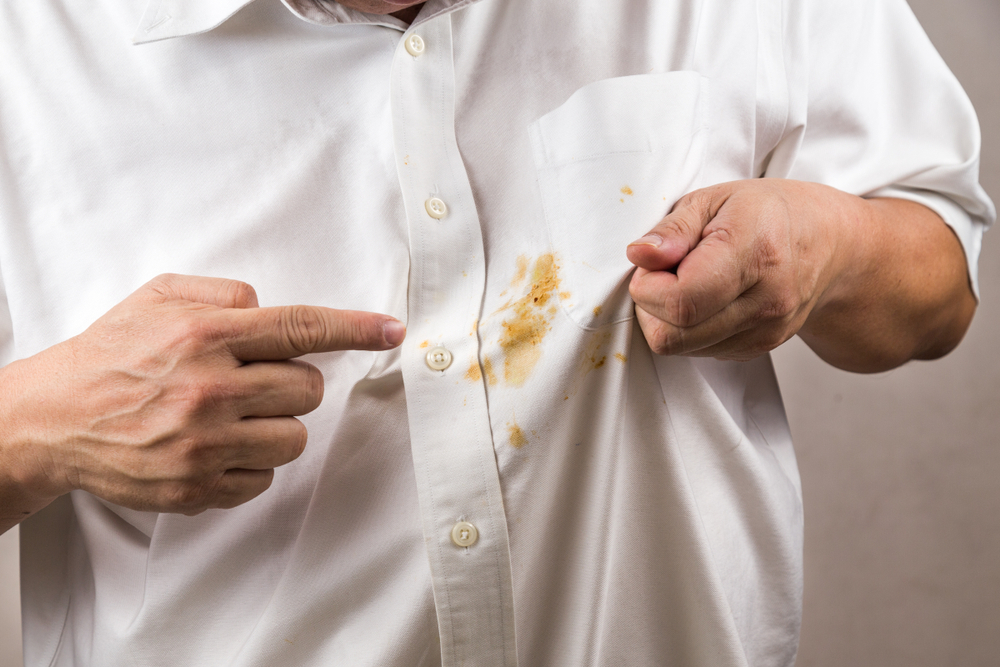 Frustrated,Person,Pointing,To,Spilled,Curry,Stain,On,White,Shirt